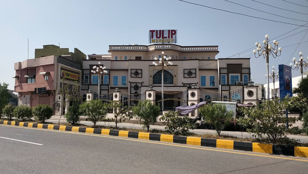 Traditional wedding marquee setup at Tulip Marquee Sialkot with floral stage and guest seating.