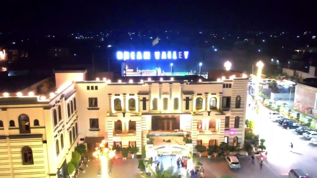 Scenic outdoor wedding lawn at Dream Valley Sialkot decorated with lights and greenery for a mehndi function.