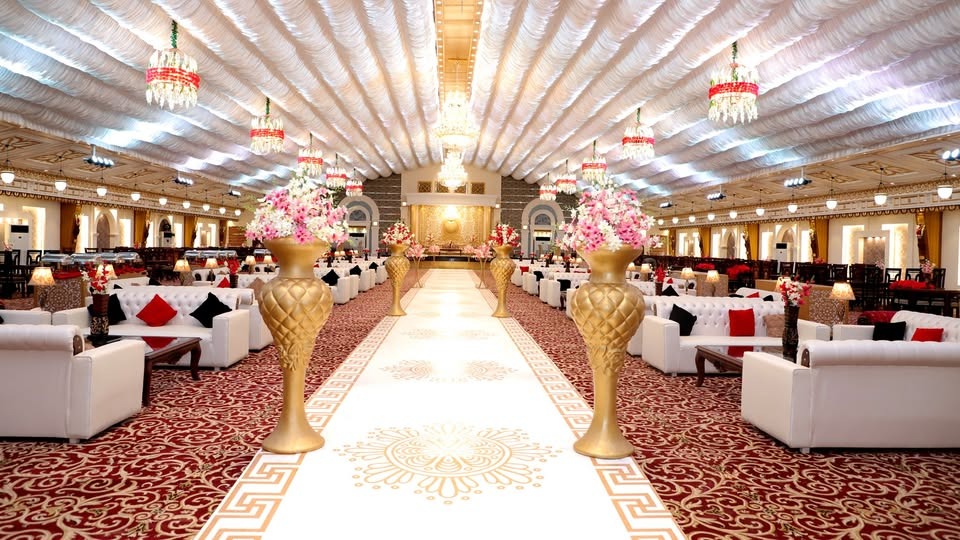 Beautifully decorated wedding hall at Dream Valley Sialkot with elegant stage and floral event décor.